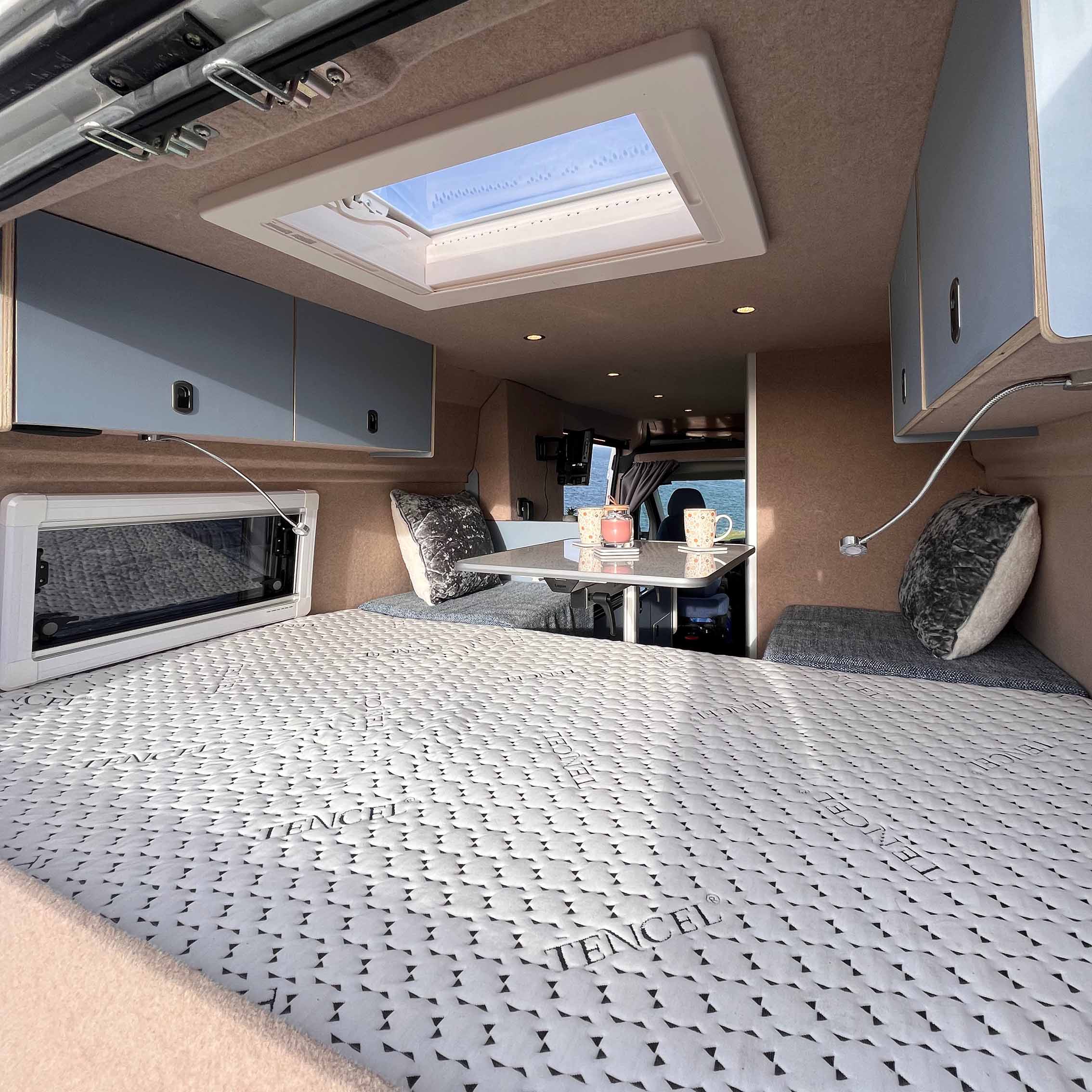 bed and sitting unit in back of van