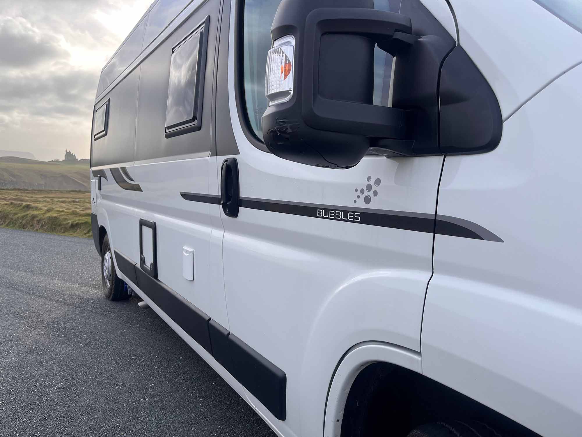 close up side view of white van