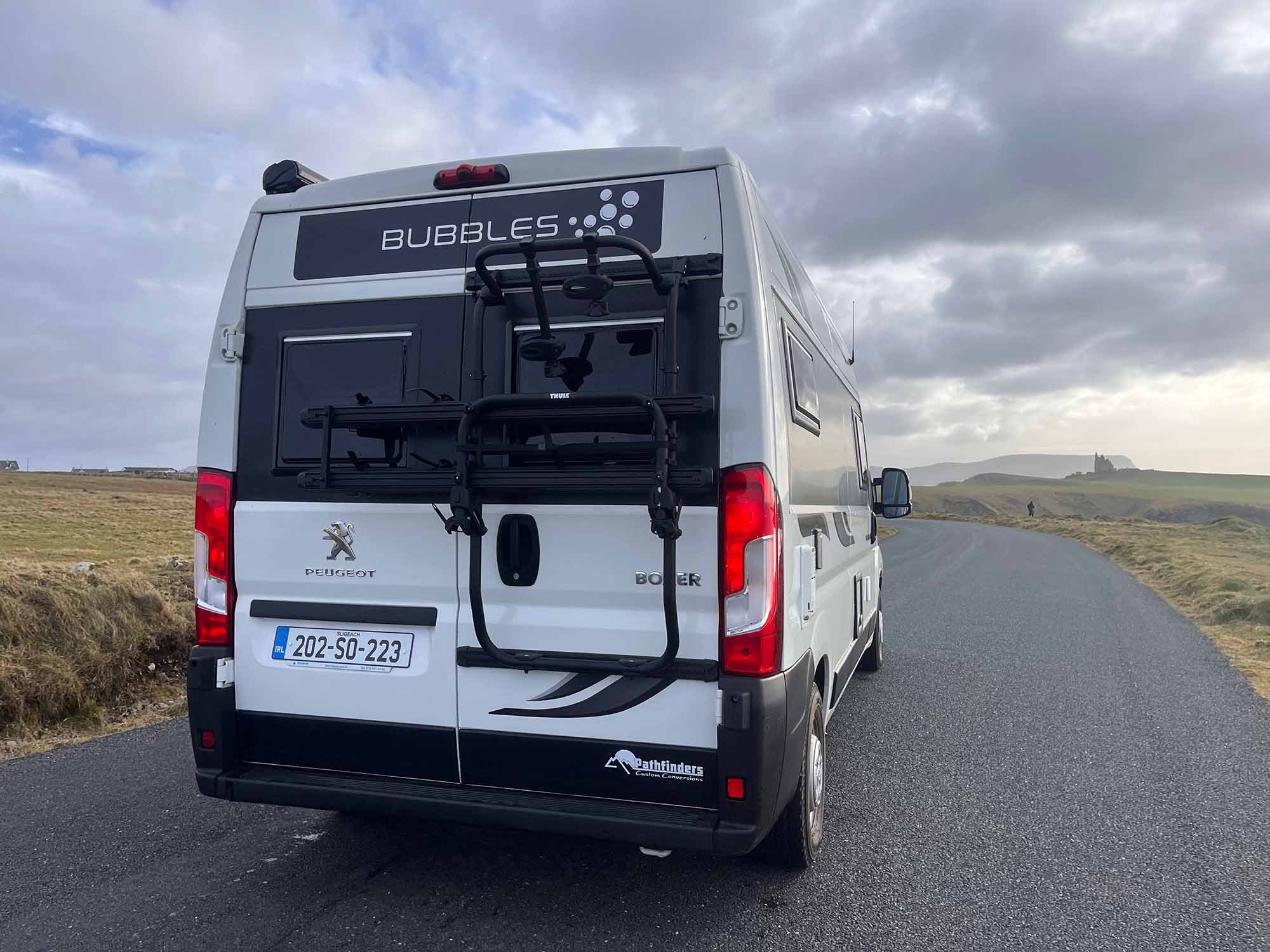 Back of white van with bike rack on it
